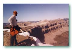 The Chinese Wall limestone escarpment rising above alpine meadows along the Continental Divide in the Bob Marshall Wilderness